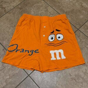 orange m&m boxer shorts featuring the “can’t resist m” graphic